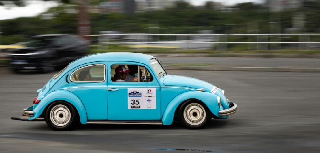 Beetle car speeding down a city street symbolising slow internet speed.