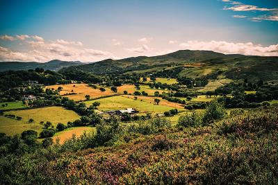 Landscape view of the countryside in Conwy, Wales, featuring hills and greenery.