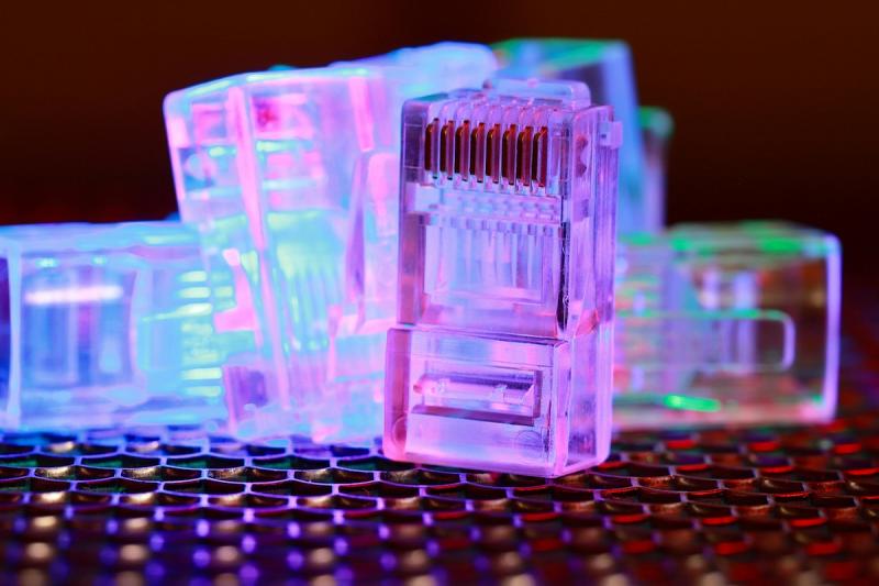 Close-up of network cable connectors with colorful lighting.