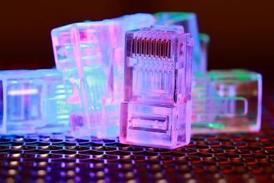 Close-up of network cable connectors with colorful lighting.